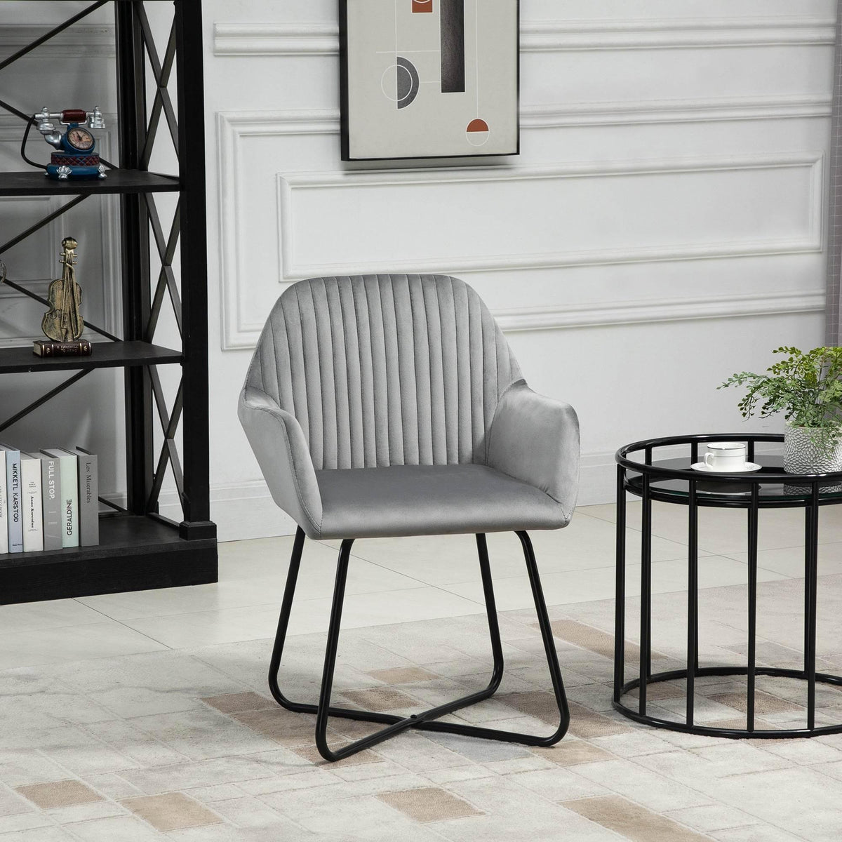 Grey accent armchair with curved back and padded arms, on black metal sled base.