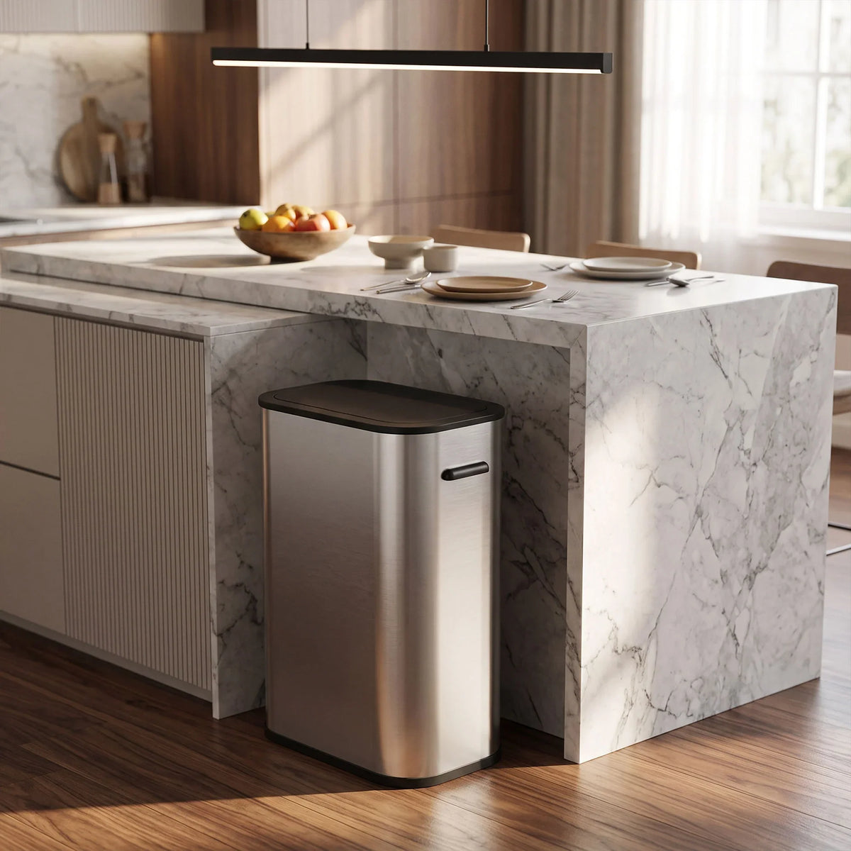 Stainless steel touchless sensor trash can with closed lid placed under kitchen island
