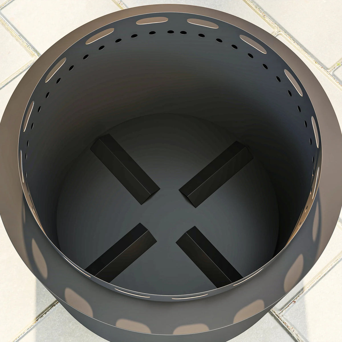 Dark grey metal fire pit top view with vent holes and inner grate