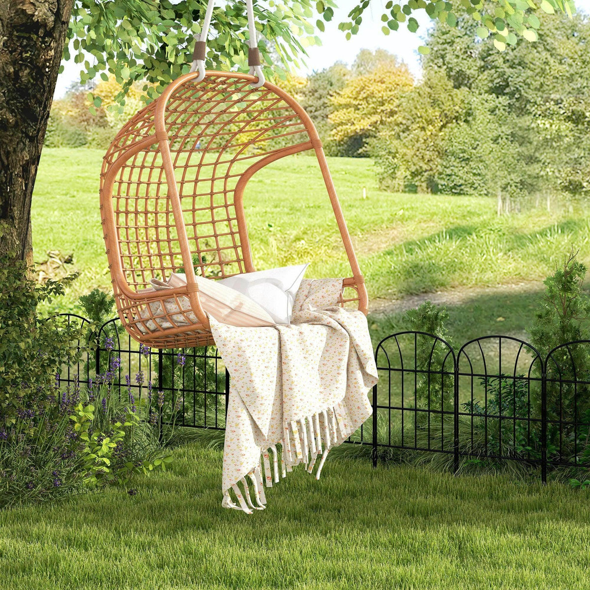 Black metal arched fence panels surrounding outdoor seating in a garden