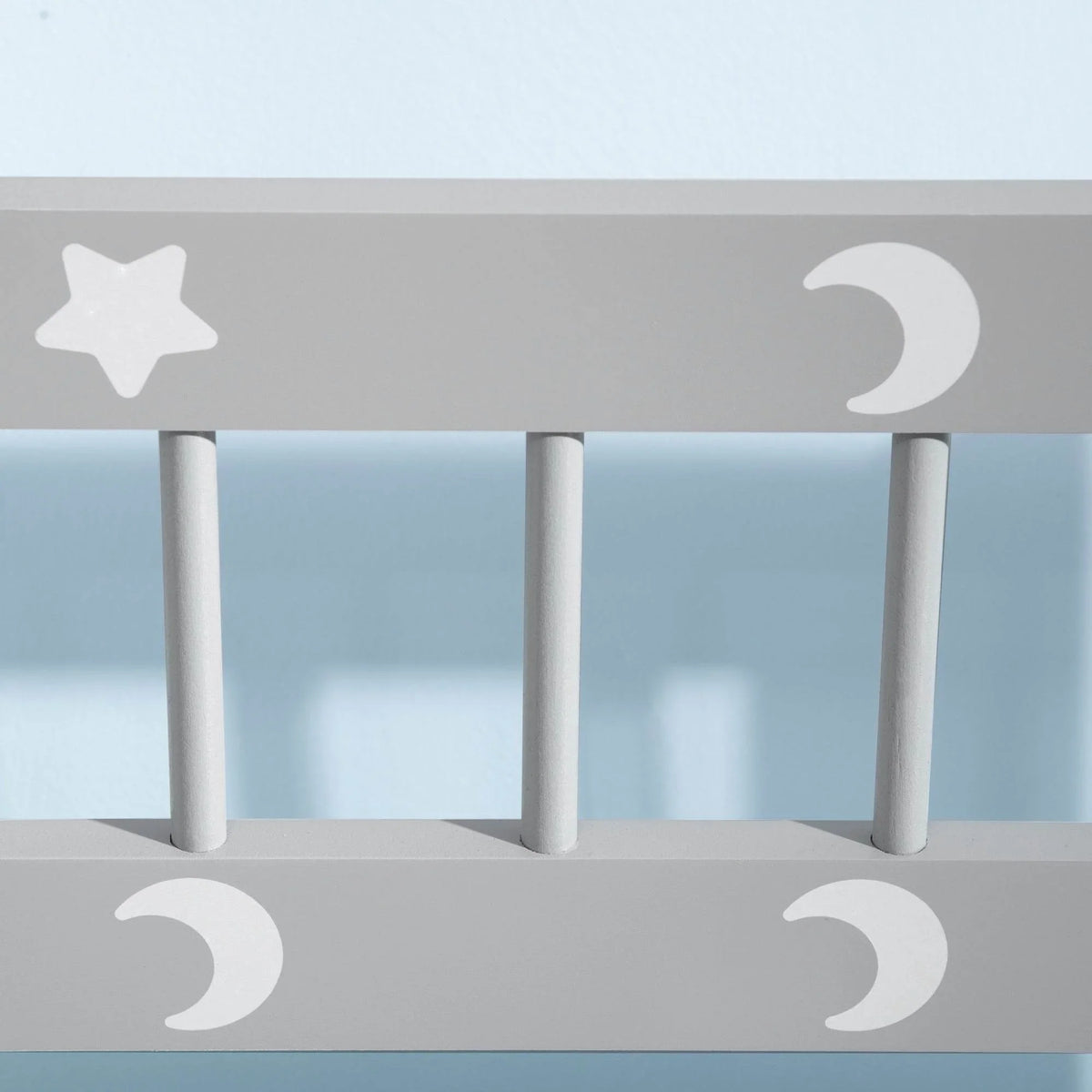 Kids bench rail with white supports and star-and-moon cutout accents.