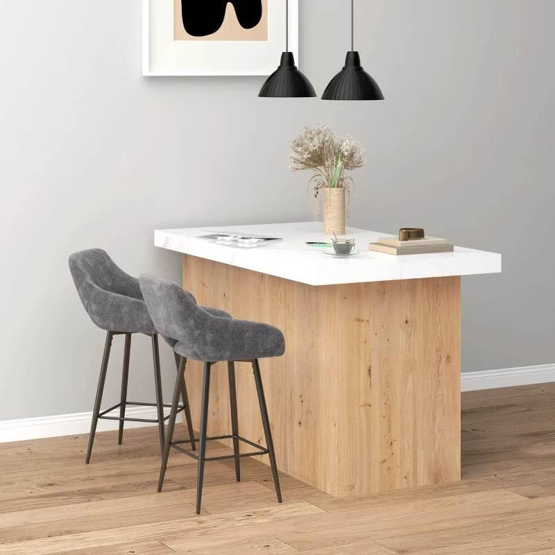 Grey velvet bar stools with curved backs, standing at a counter with metal footrests.