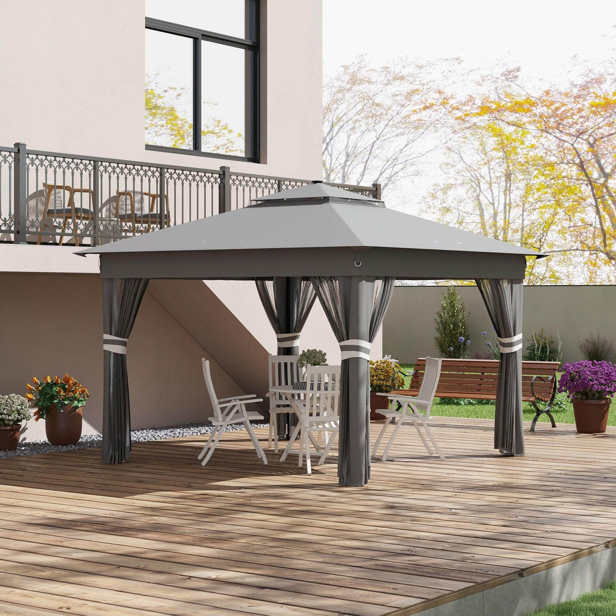 Grey pop-up gazebo tent with dark curtains and mesh side panels on an outdoor deck