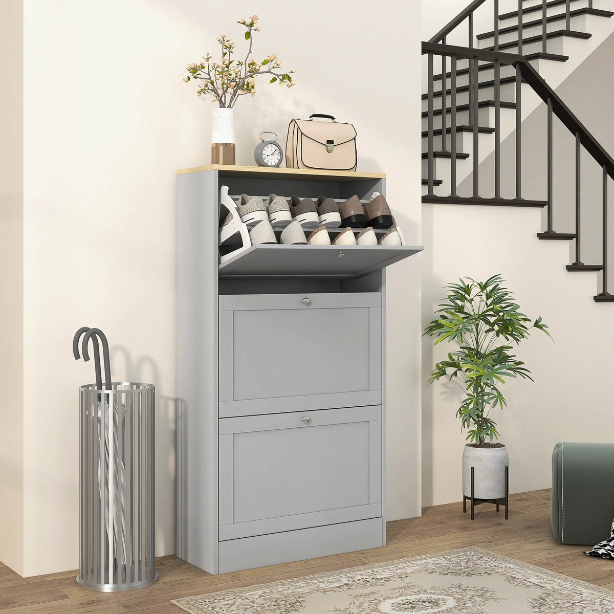 Grey shoe storage cabinet with three flip drawers and open shelving for multiple pairs