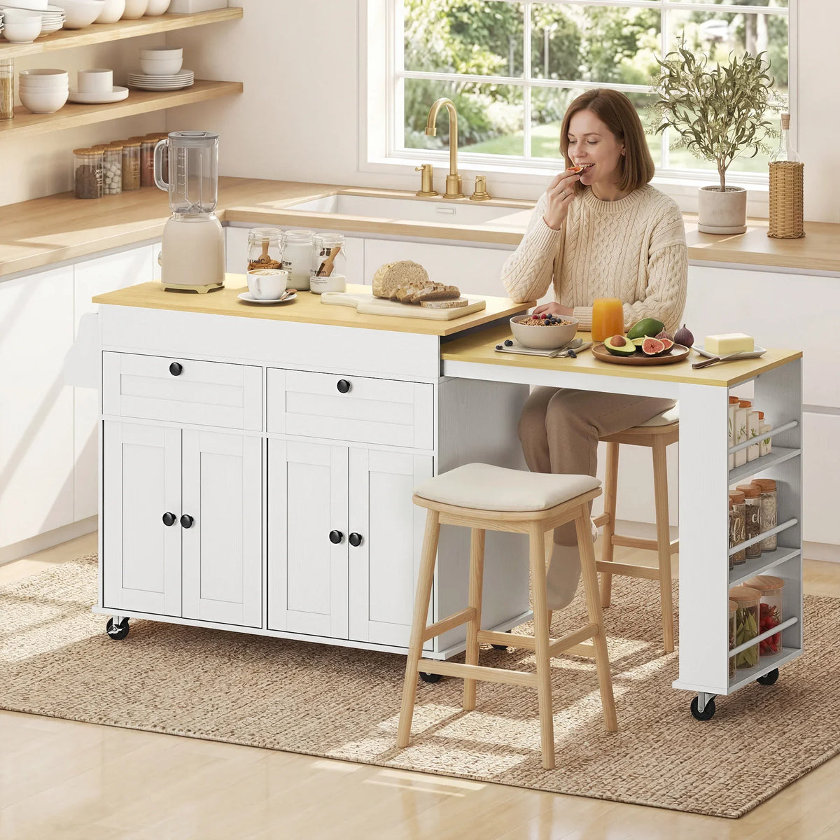 Rolling kitchen island with expandable countertop, white cabinet doors, side shelves and stool.