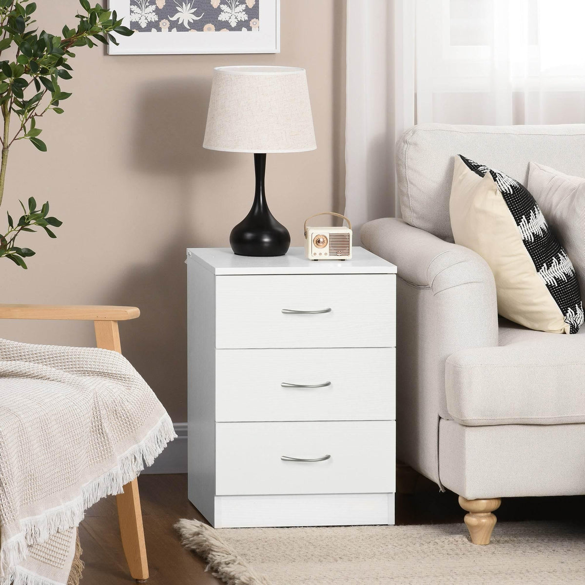 White three-drawer nightstand with curved metal pulls and open top surface