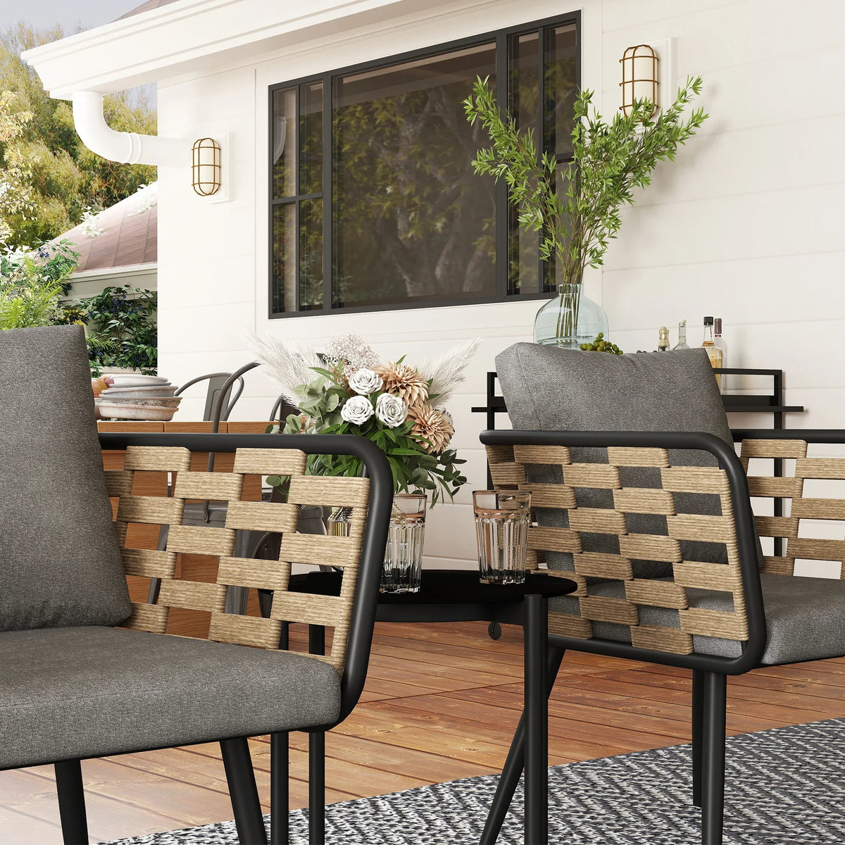 Two outdoor rattan armchairs with gray cushions and woven tan back panels