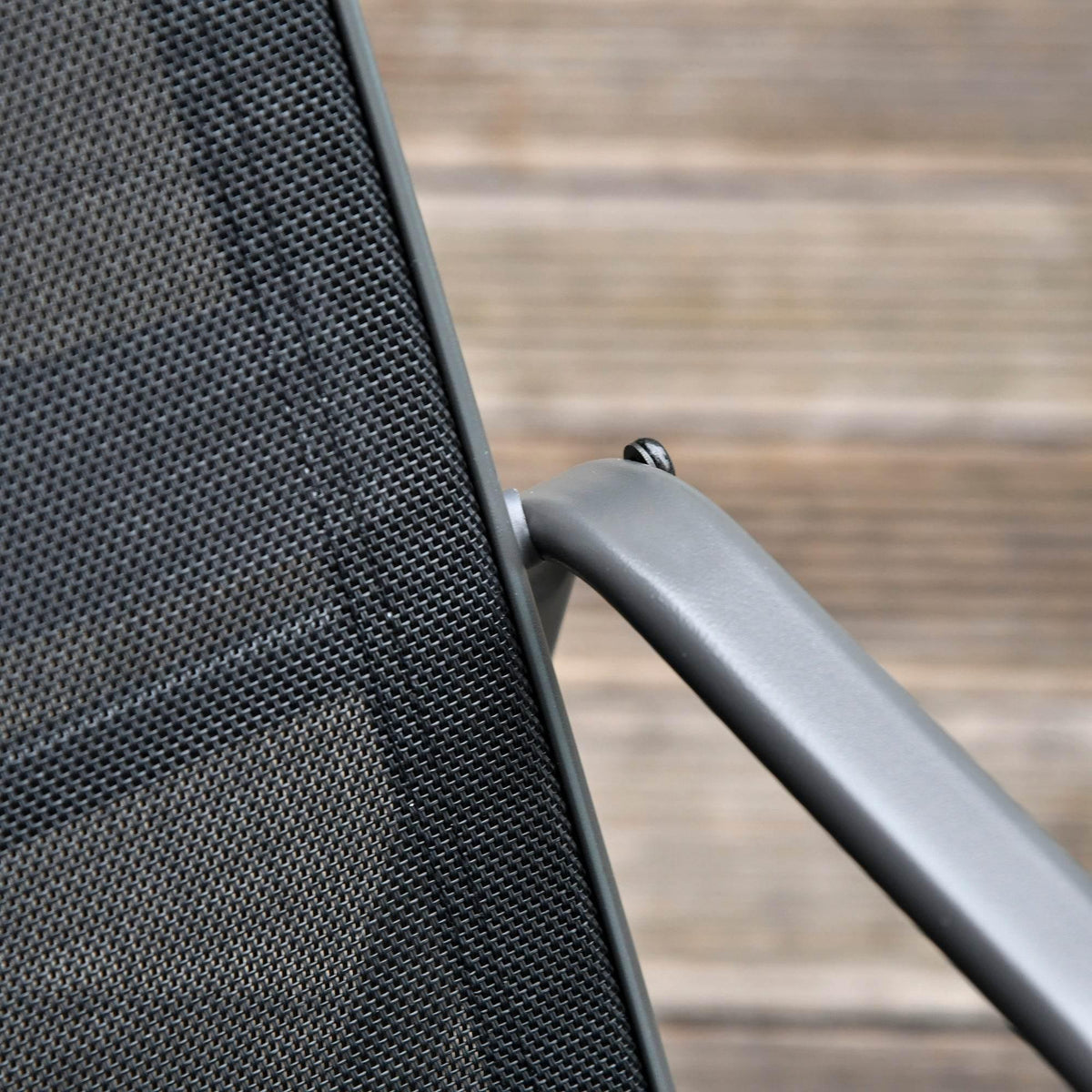 Close-up of dark textilene chair fabric on a powder-coated metal frame