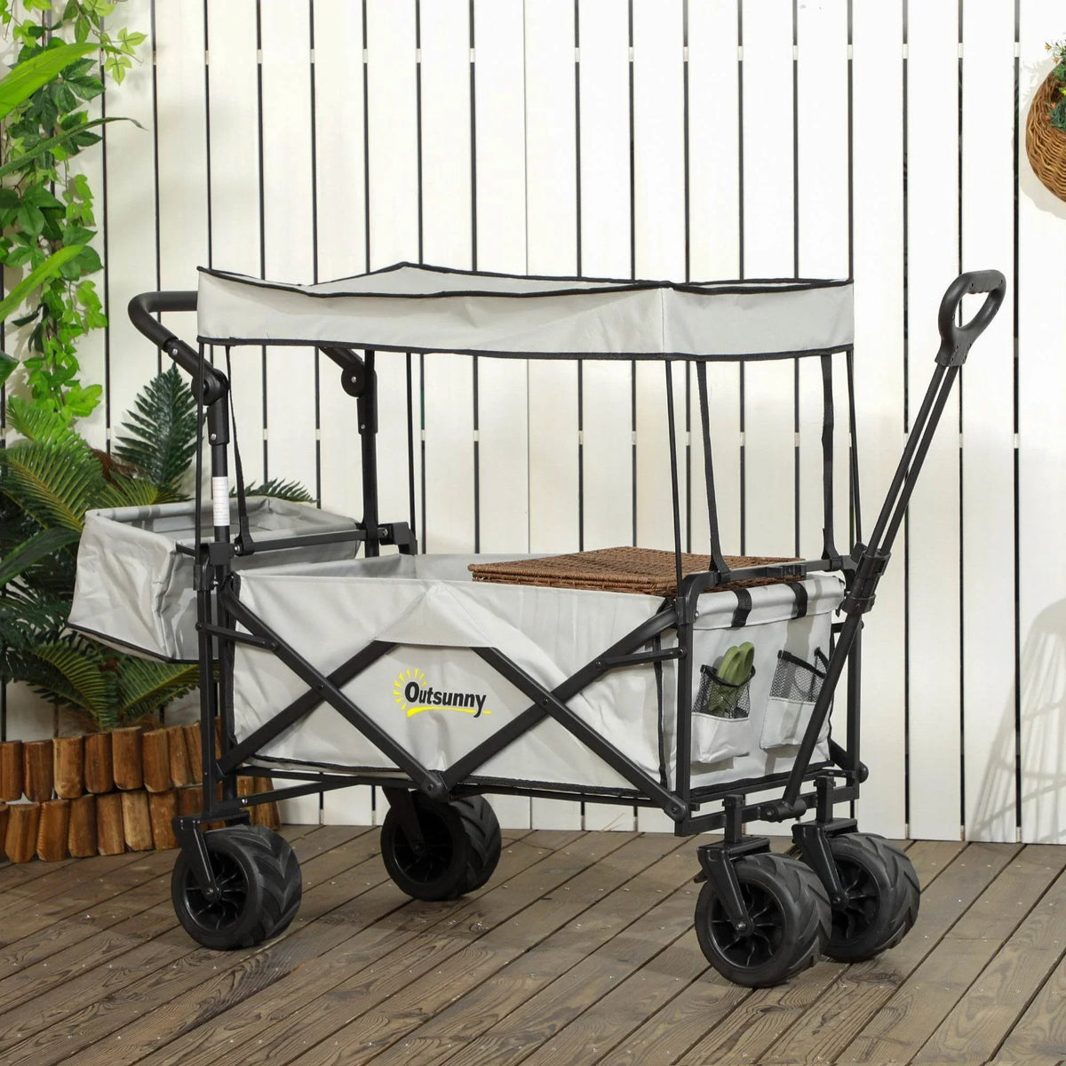 Grey folding beach wagon with canopy, front organizer storage, and four caster wheels.