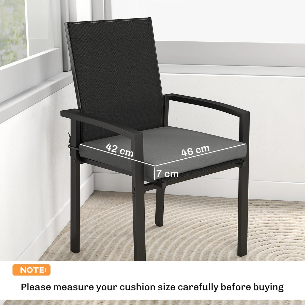 Dark grey outdoor seat cushion with removable cover on a matching armchair