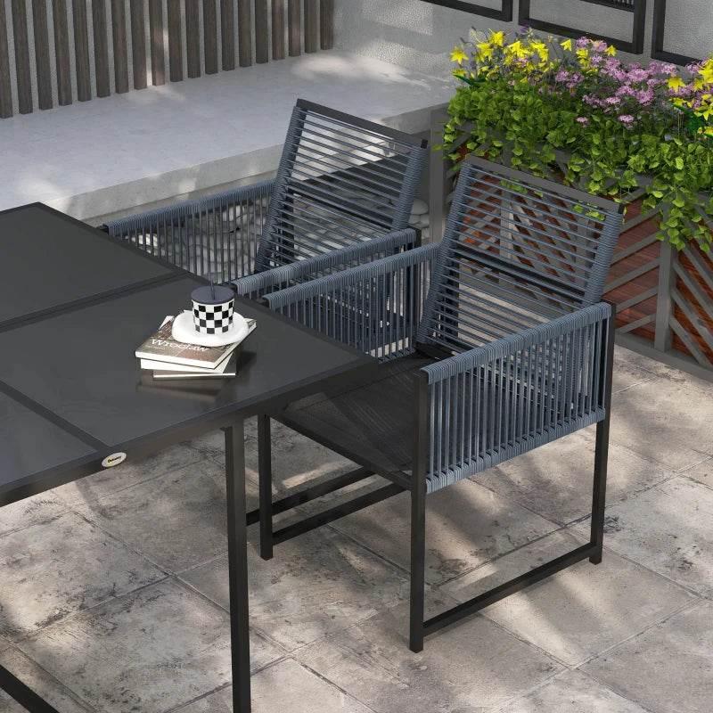 Outdoor rectangular dining table with four metal chairs, folding backs and woven seats