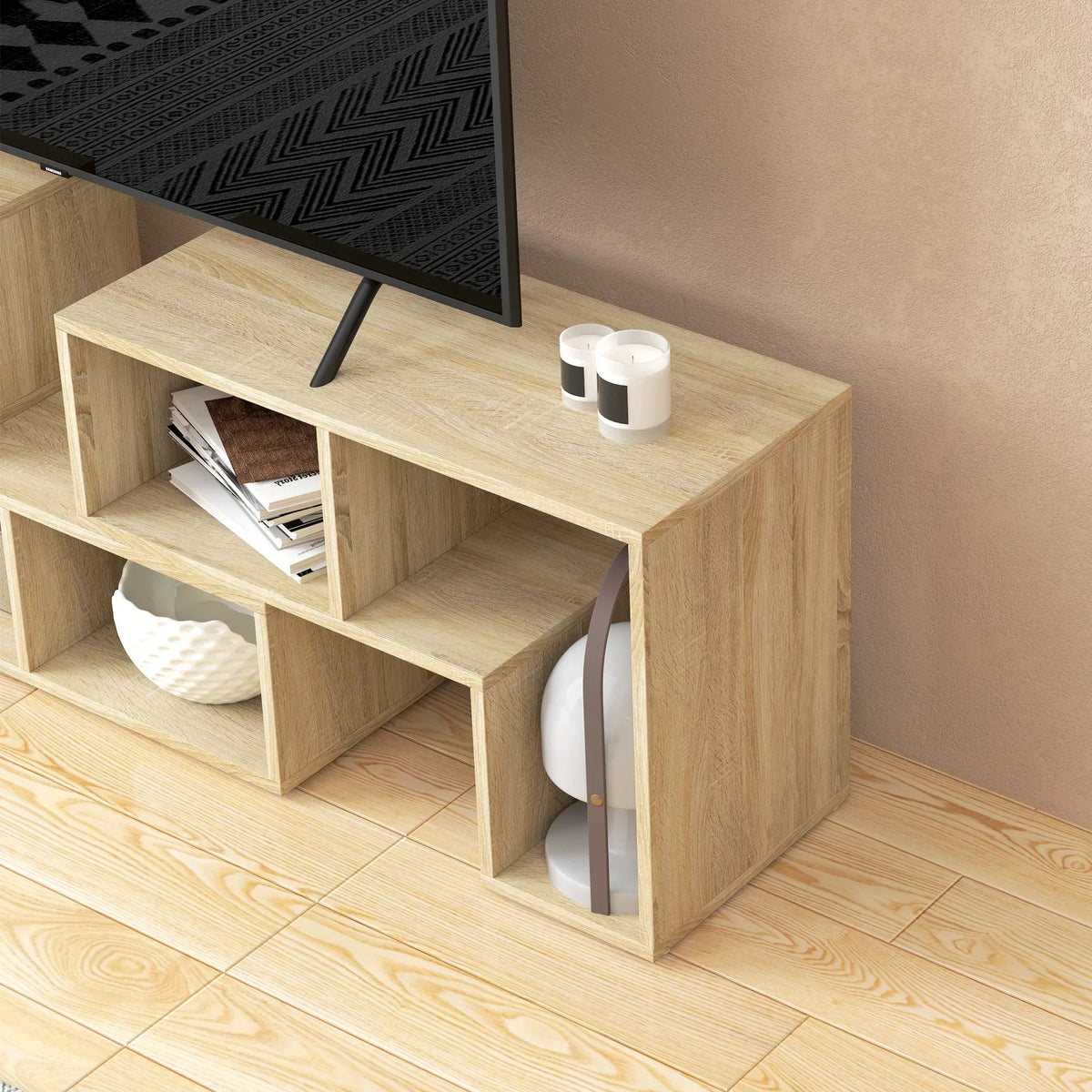 Close-up of light wood-effect TV console corner with open shelves and protective foot pads