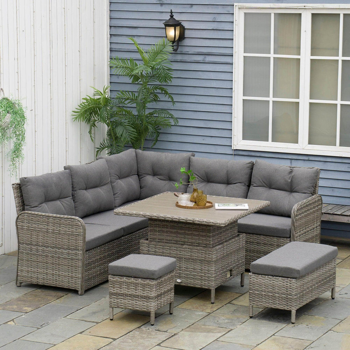 Outdoor rattan sectional sofa with gray cushions and woven corner bench