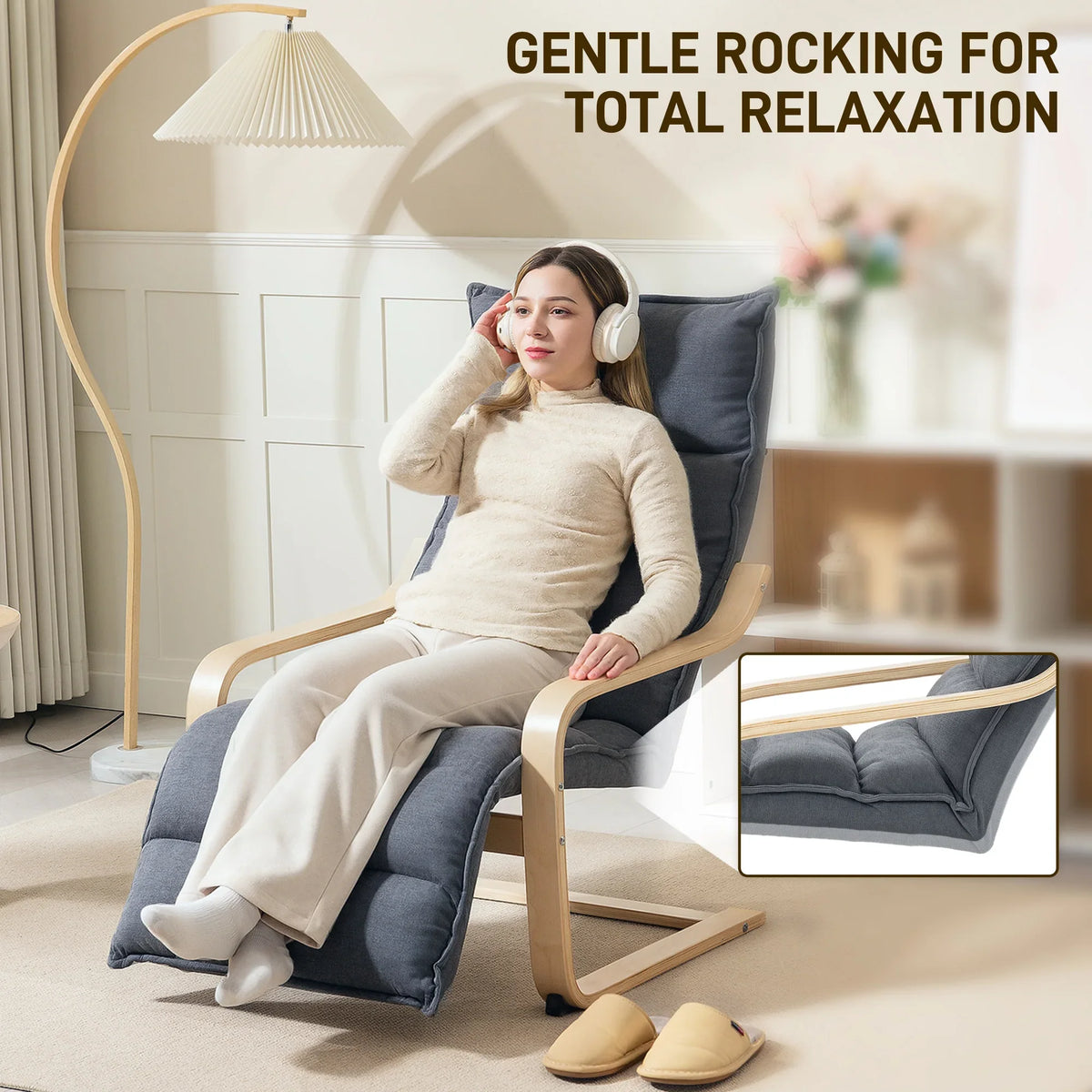 Dark grey velvet rocking recliner with adjustable footrest and light birch frame, seated person