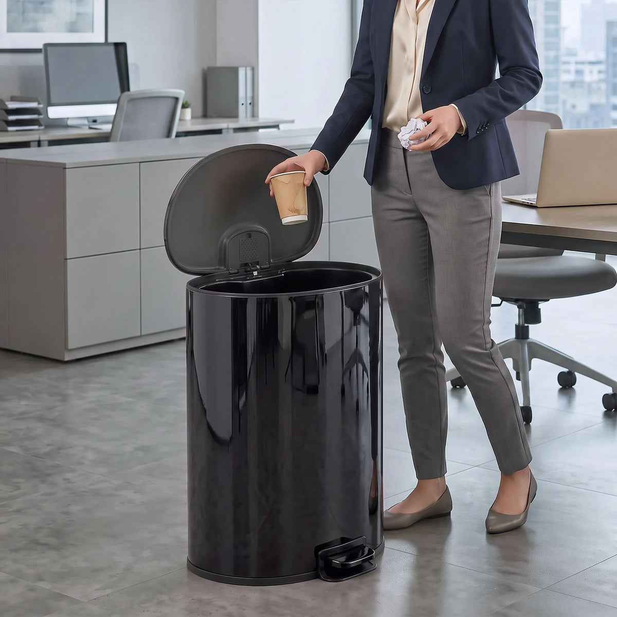 Black stainless-steel kitchen pedal bin with lid open for hands-free disposal