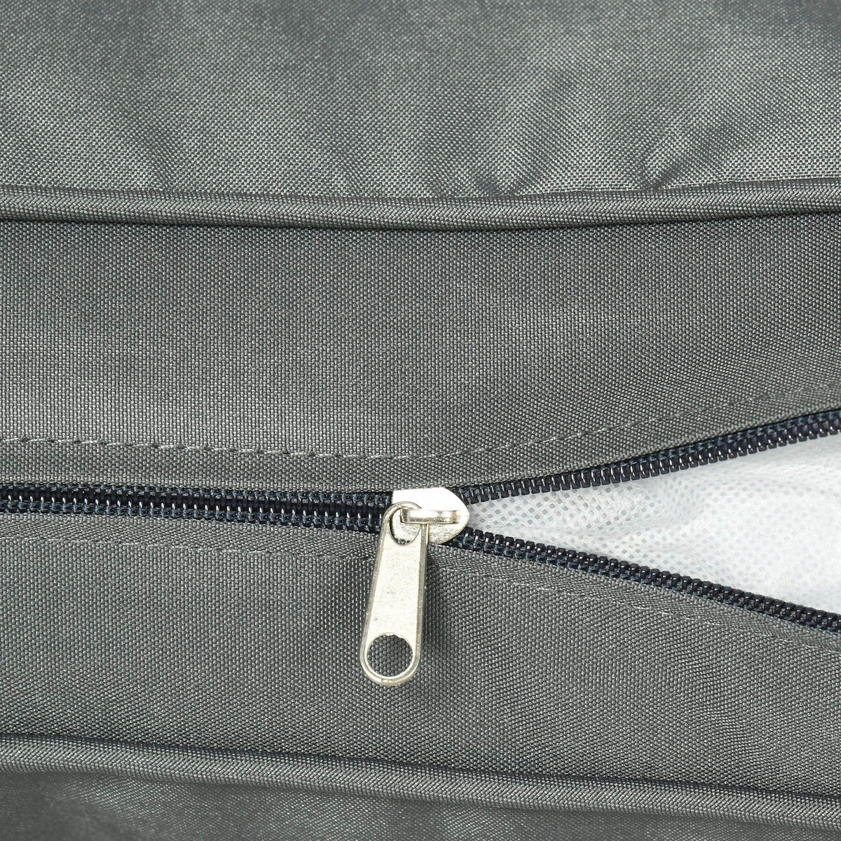 Dark gray cushion cover with visible zipper and metal pull tab