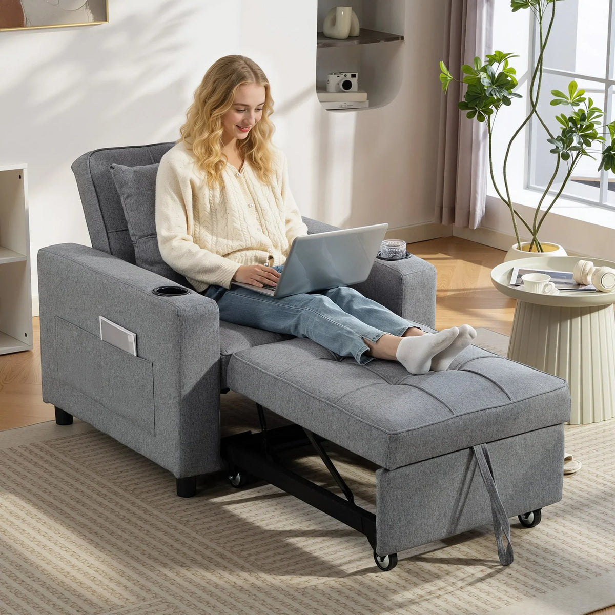 Dark grey sofa bed chair with padded arms and seat, convertible to lounger