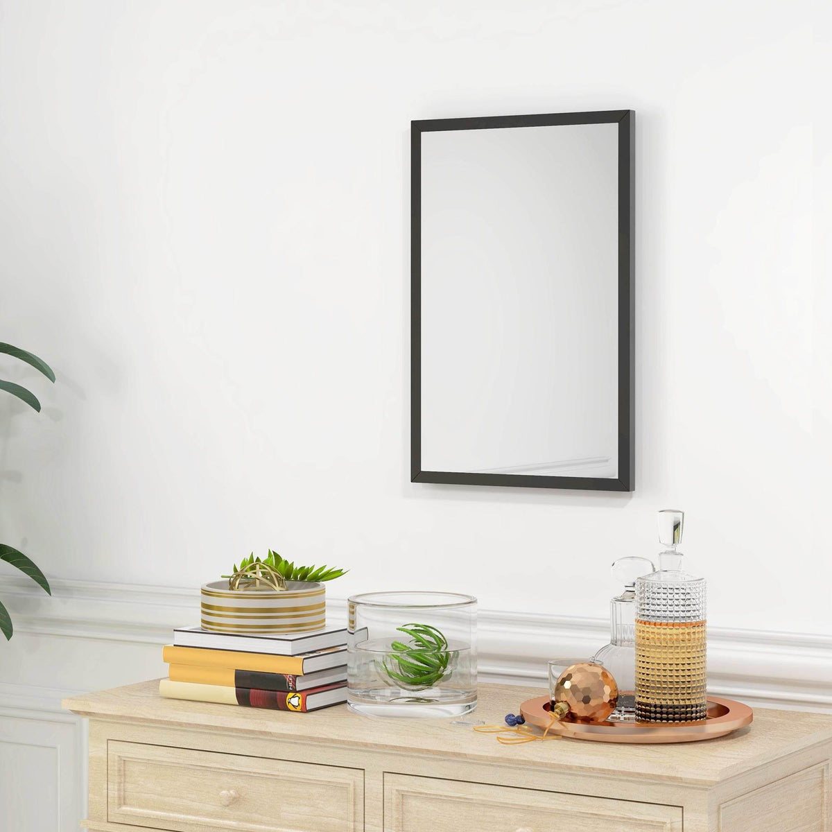 Rectangular black wall mirror with slim frame, mounted vertically on a wall