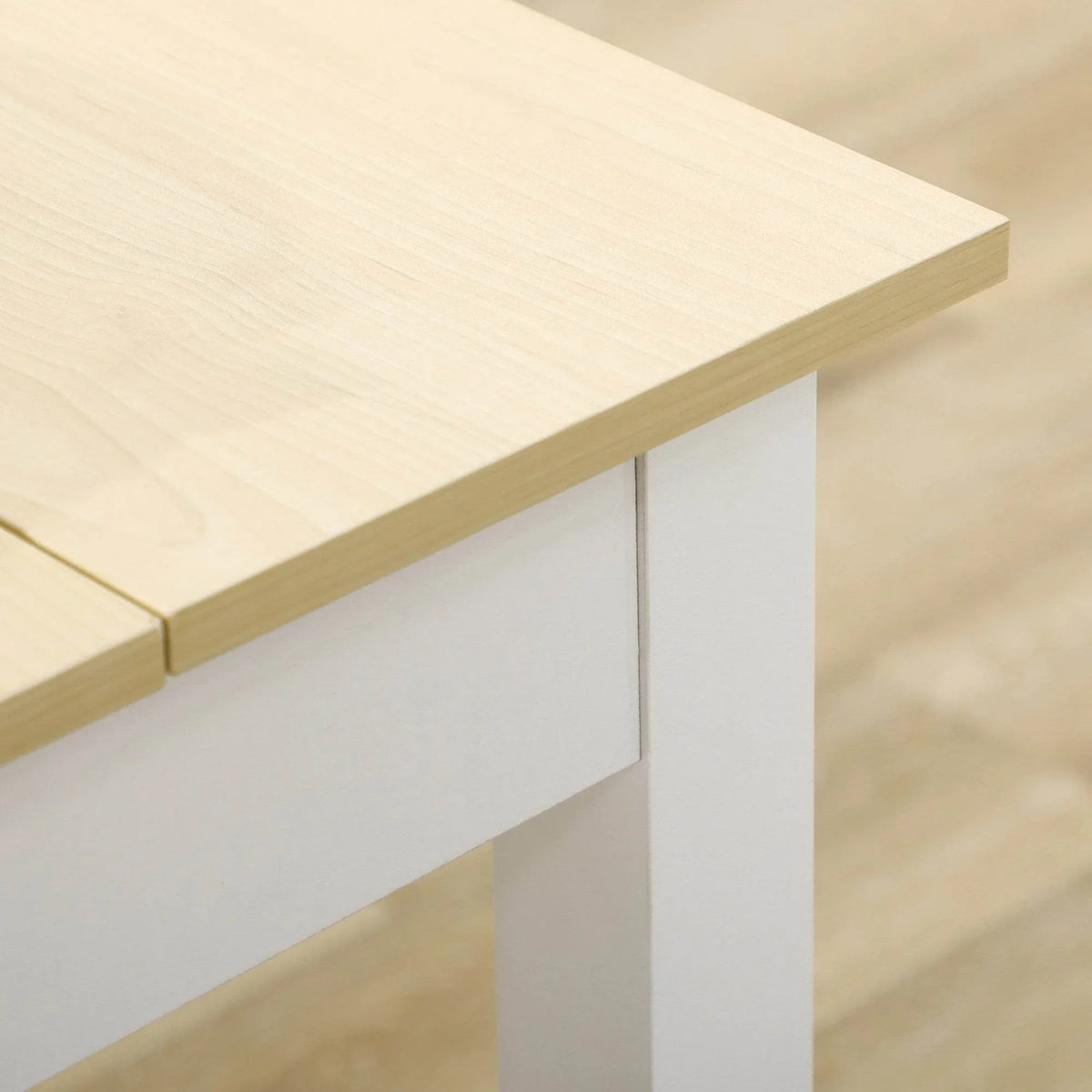 Detail of light wood tabletop edge and white corner leg support