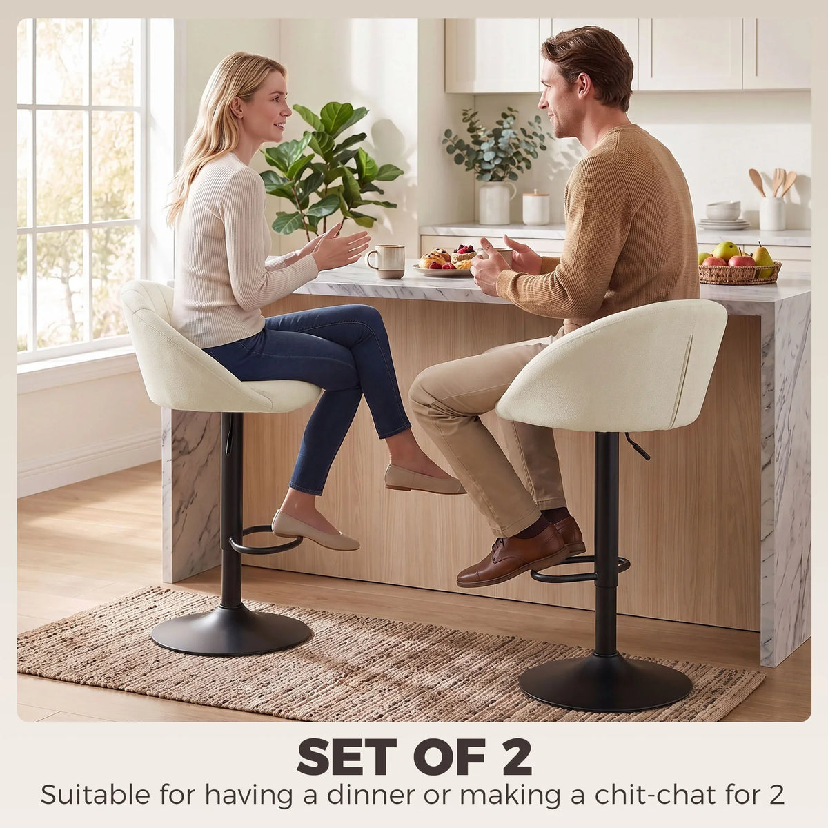 Set of two cream padded swivel bar stools with black bases and footrests for counter seating
