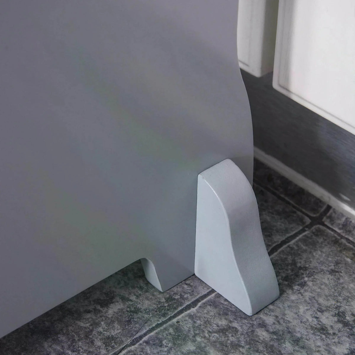 Grey wooden step stool base with stabilizing leg foot