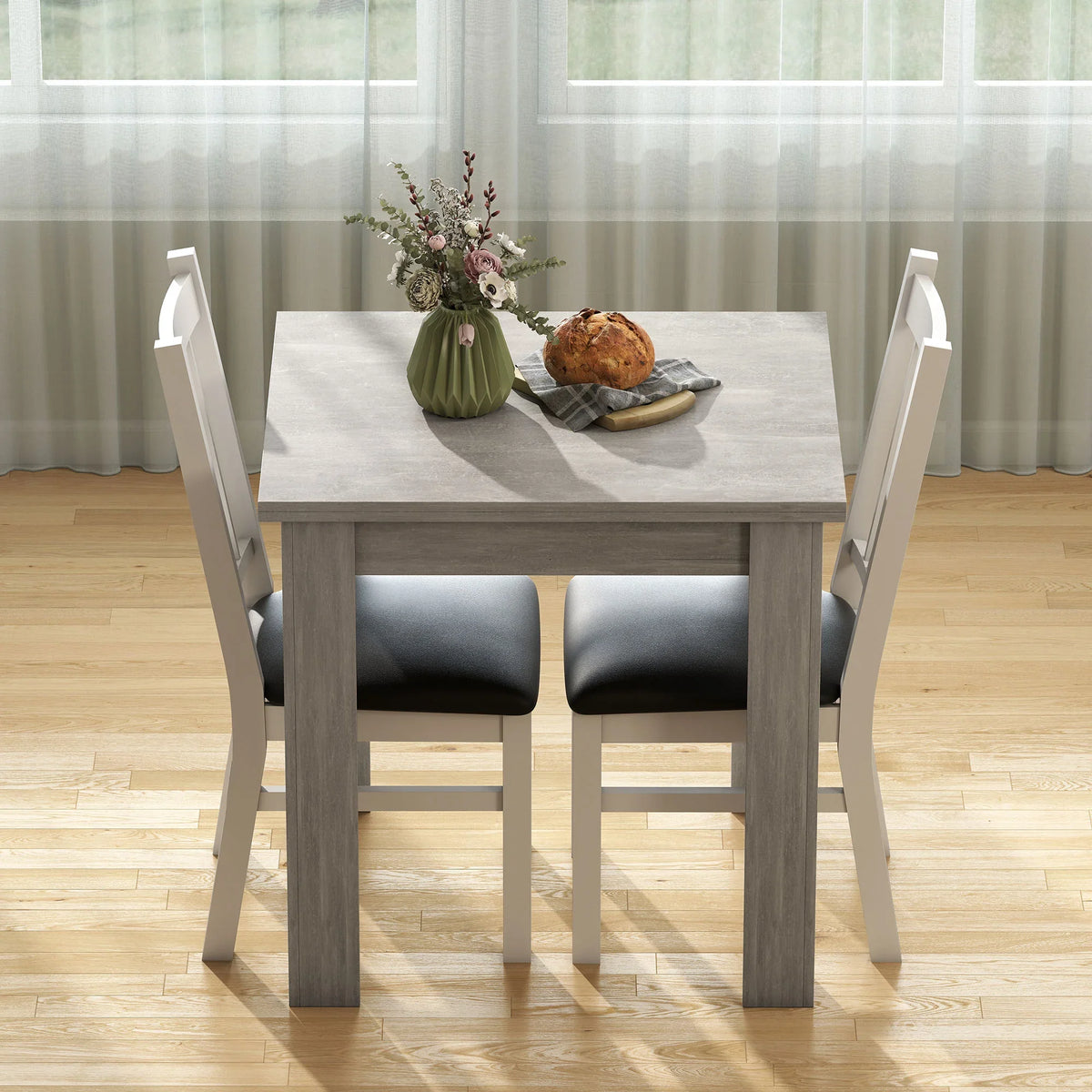 Grey dining table with drop-leaf top and four chairs, ready for a meal