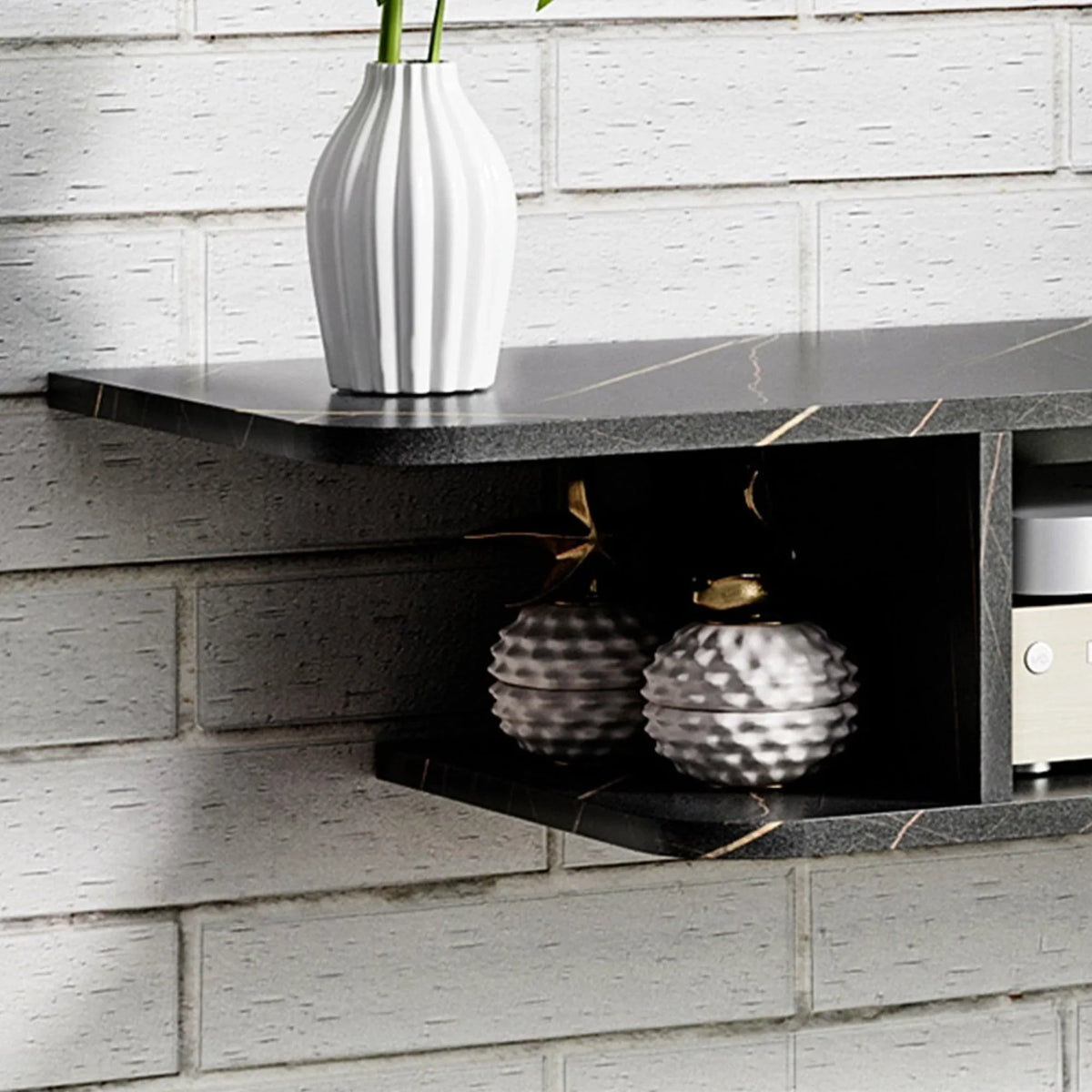 Black floating TV stand with open lower shelf holding decorative jars.