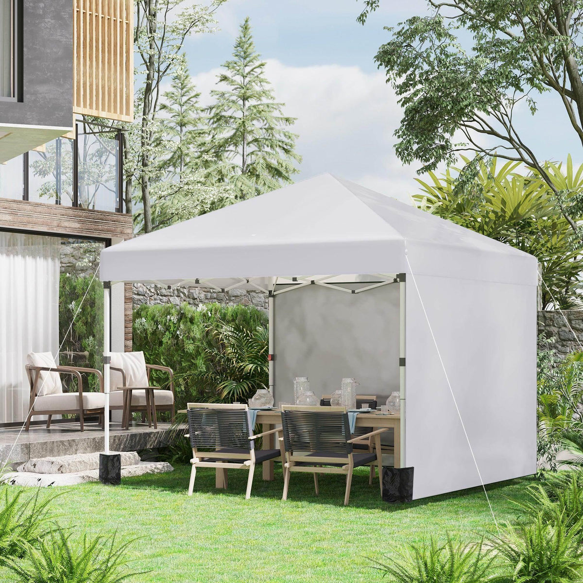 White pop-up gazebo party tent with 2 attached sidewalls and open front on lawn.