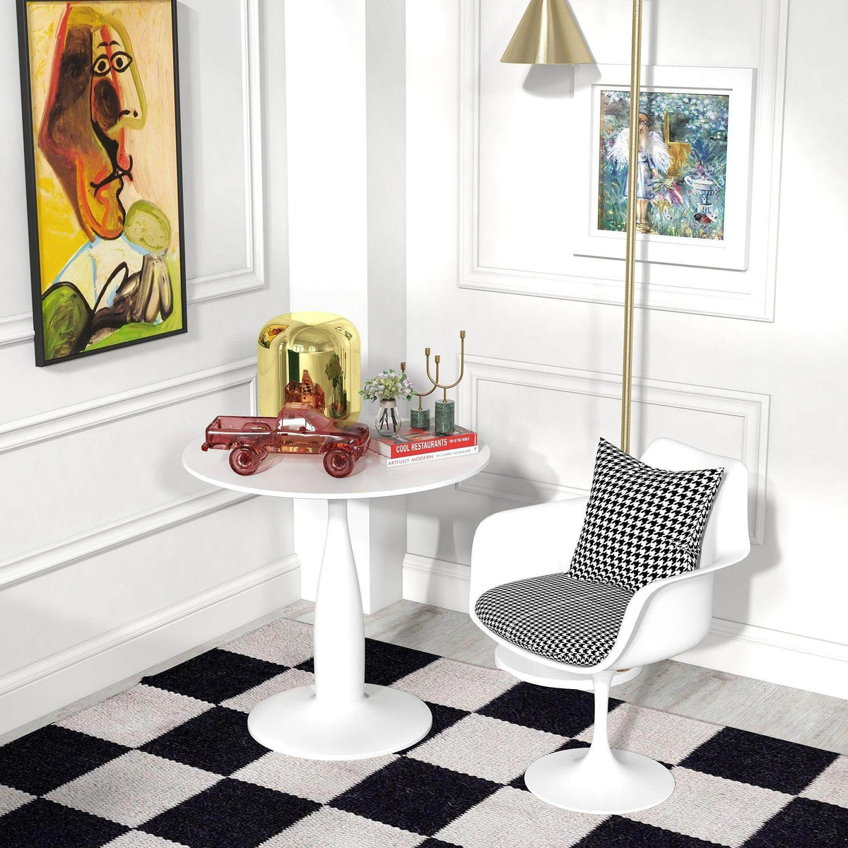 White round pedestal dining table with chair pair and decor