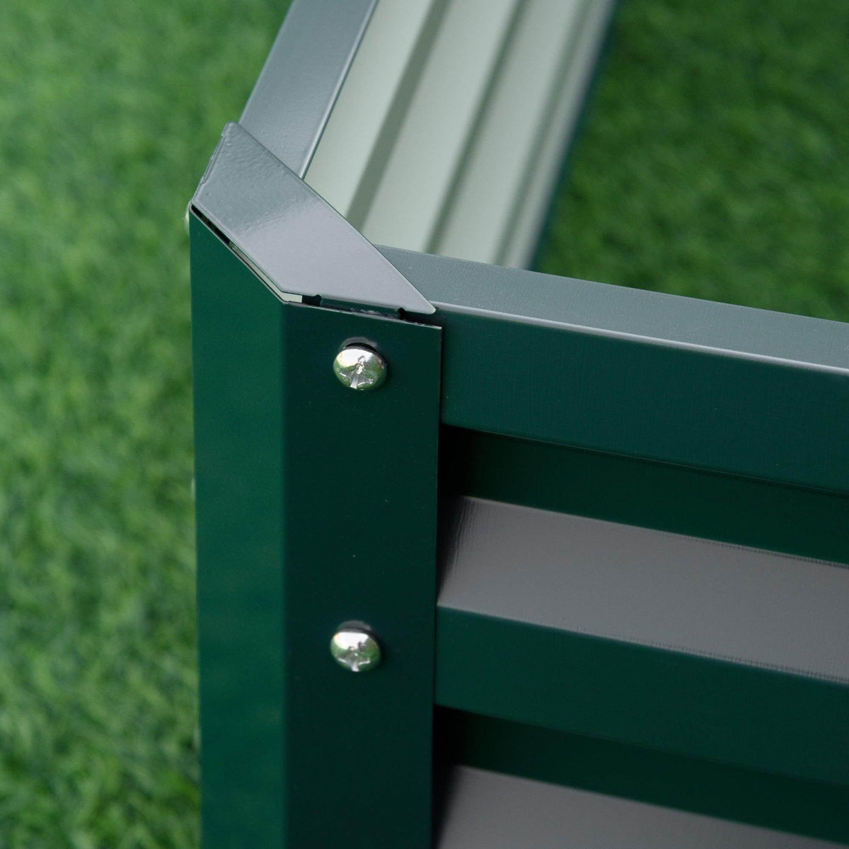 Green metal raised garden bed corner with round bolts and reinforced edge