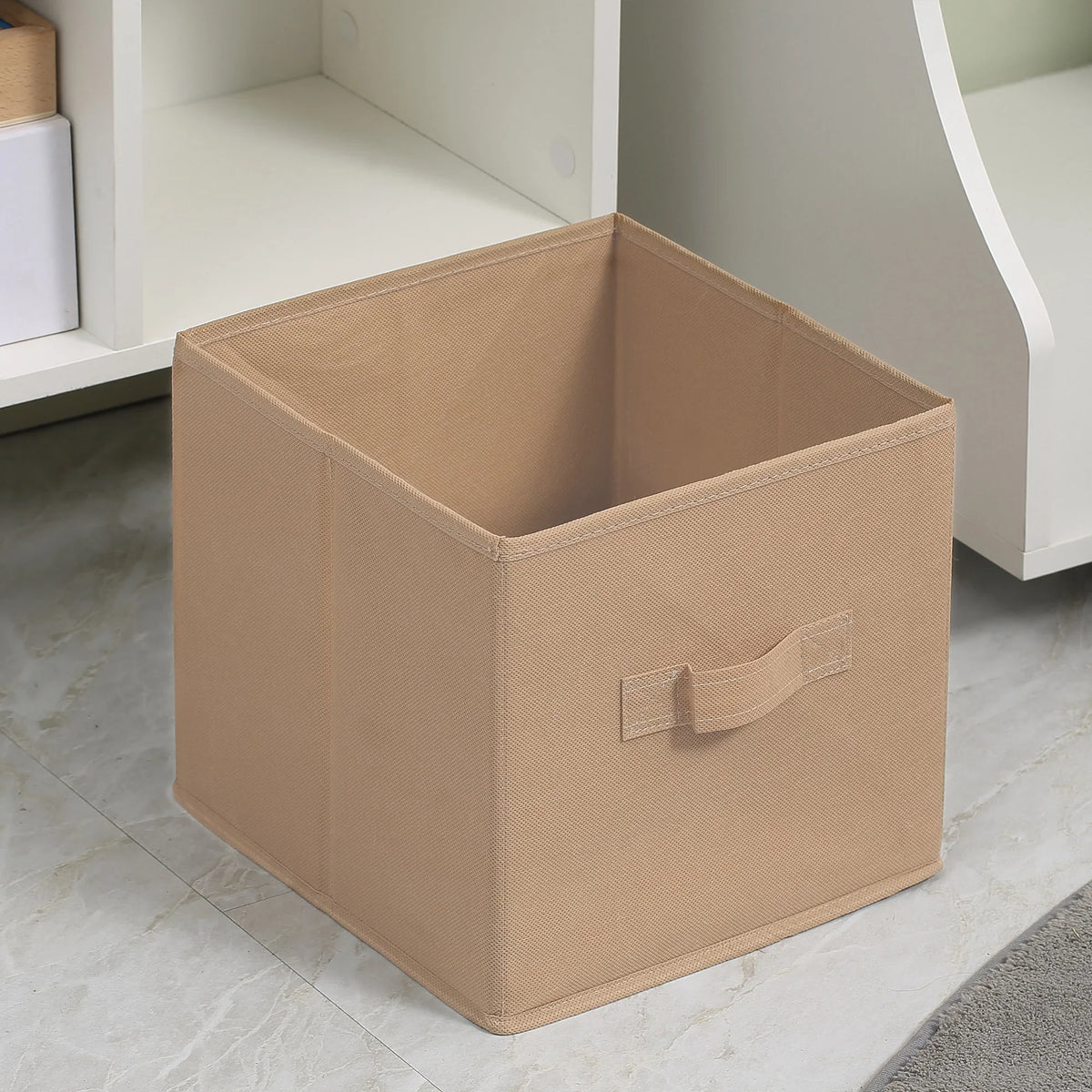 Beige fabric storage drawer with handle, open top, inside white cube cabinet