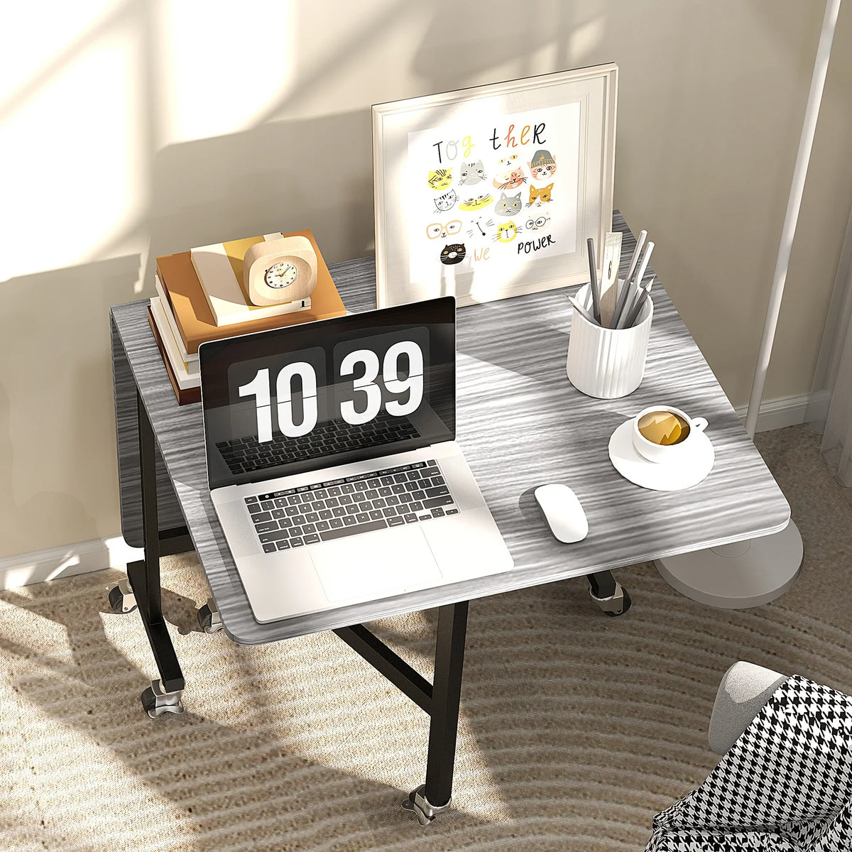 Grey drop-leaf dining table with caster wheels, extended surface for meals or work
