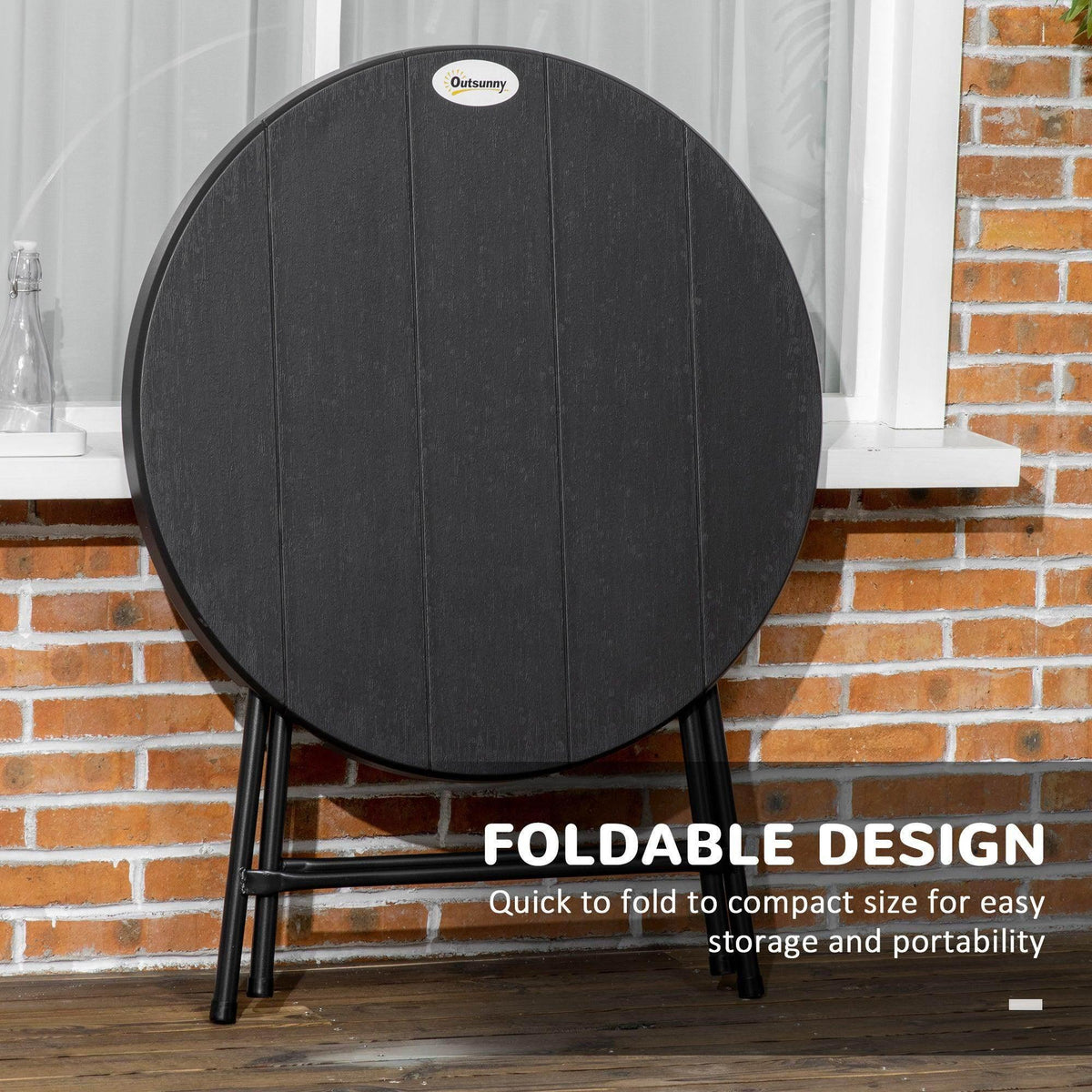 Round foldable garden dining table with dark, wood-grain-look top and black legs