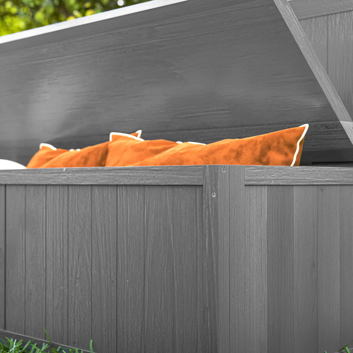 Grey storage bench with open lid showing interior compartment and cushions