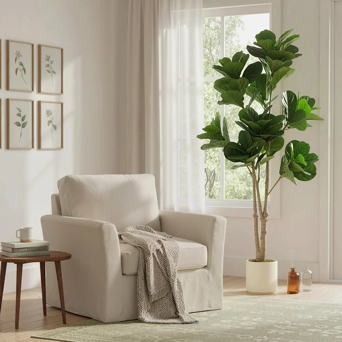 Tall artificial fiddle-leaf fig tree with green leaves and textured trunk in white planter