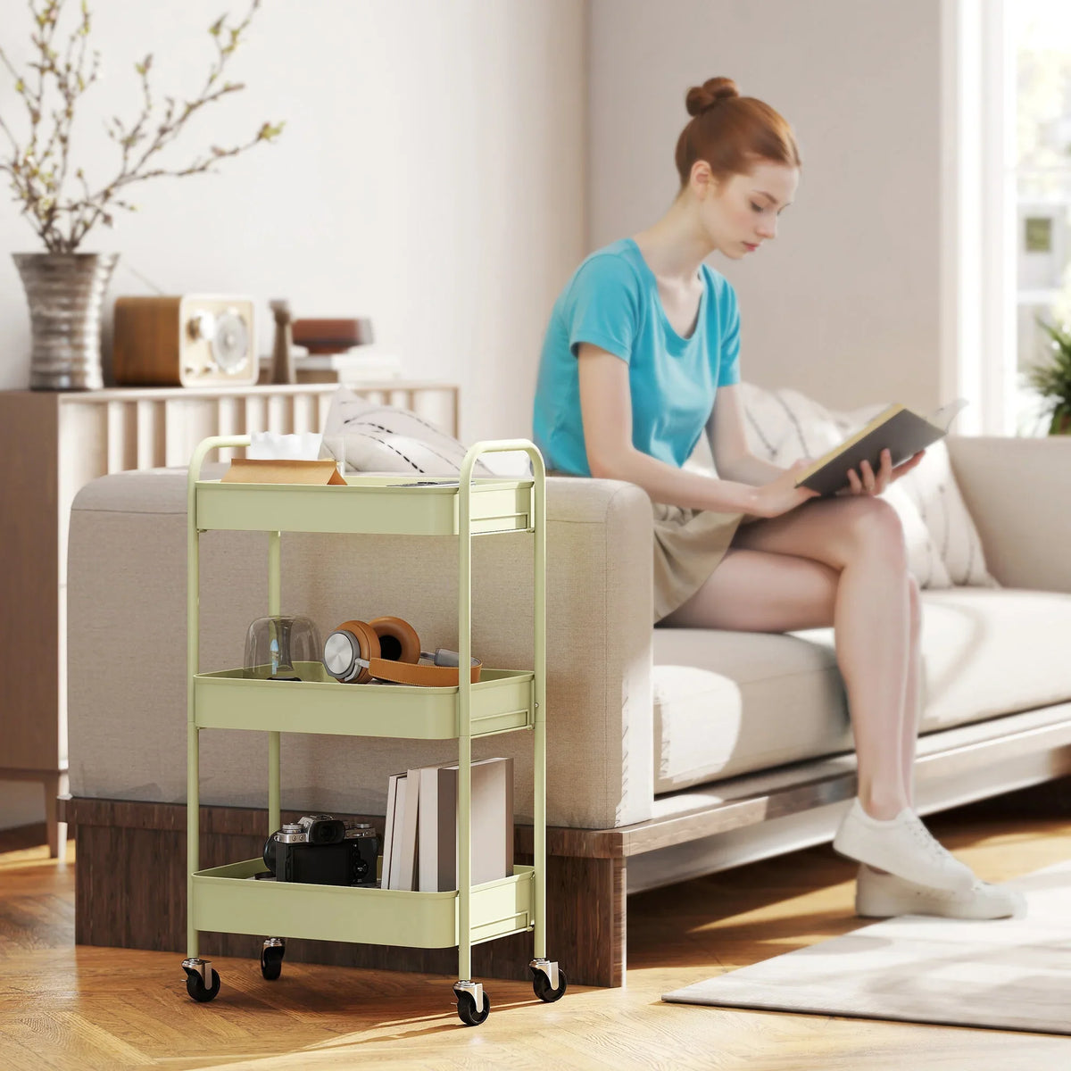Green three-tier rolling cart with mesh basket shelves, used beside sofa