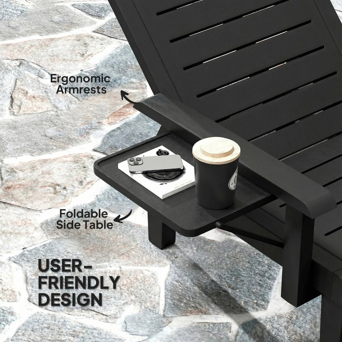 Black sun lounger with ergonomic armrests and foldable side table attachment.
