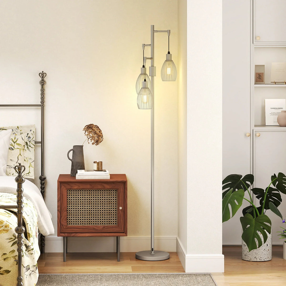 Industrial standing lamp with three caged bulb shades on silver pole and round base