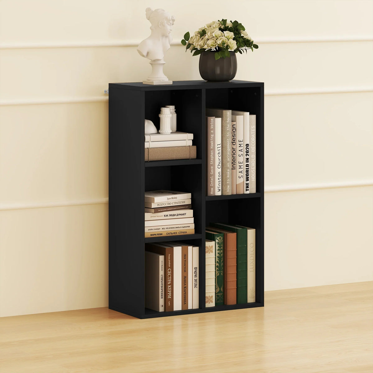 Black floor bookshelf with five open storage cubes, books and decor inside