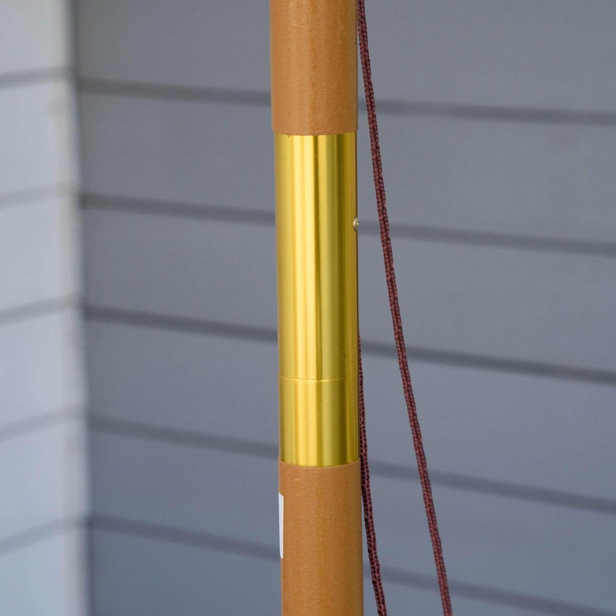 Gold umbrella pole sleeve with maroon rope detail
