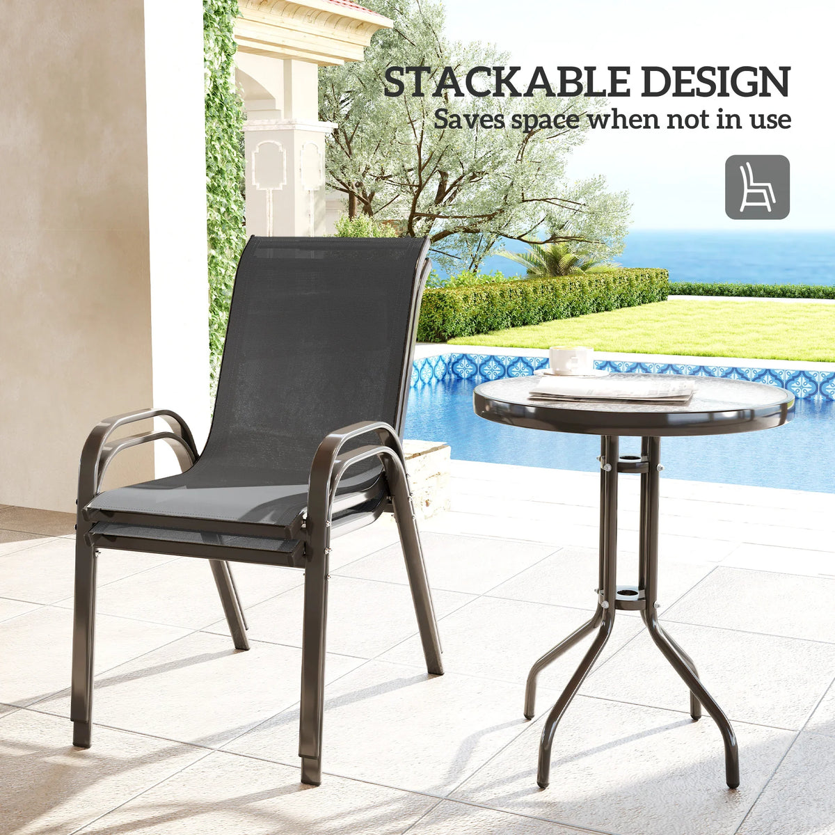 Stackable grey mesh patio chair beside round glass-top table