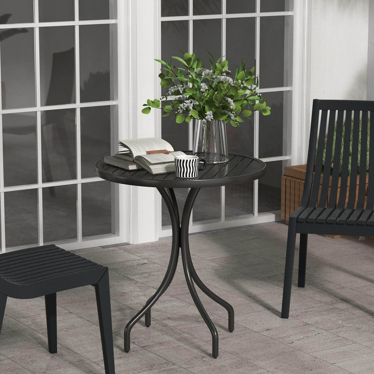 Black round patio side table with slatted tabletop and three curved steel legs