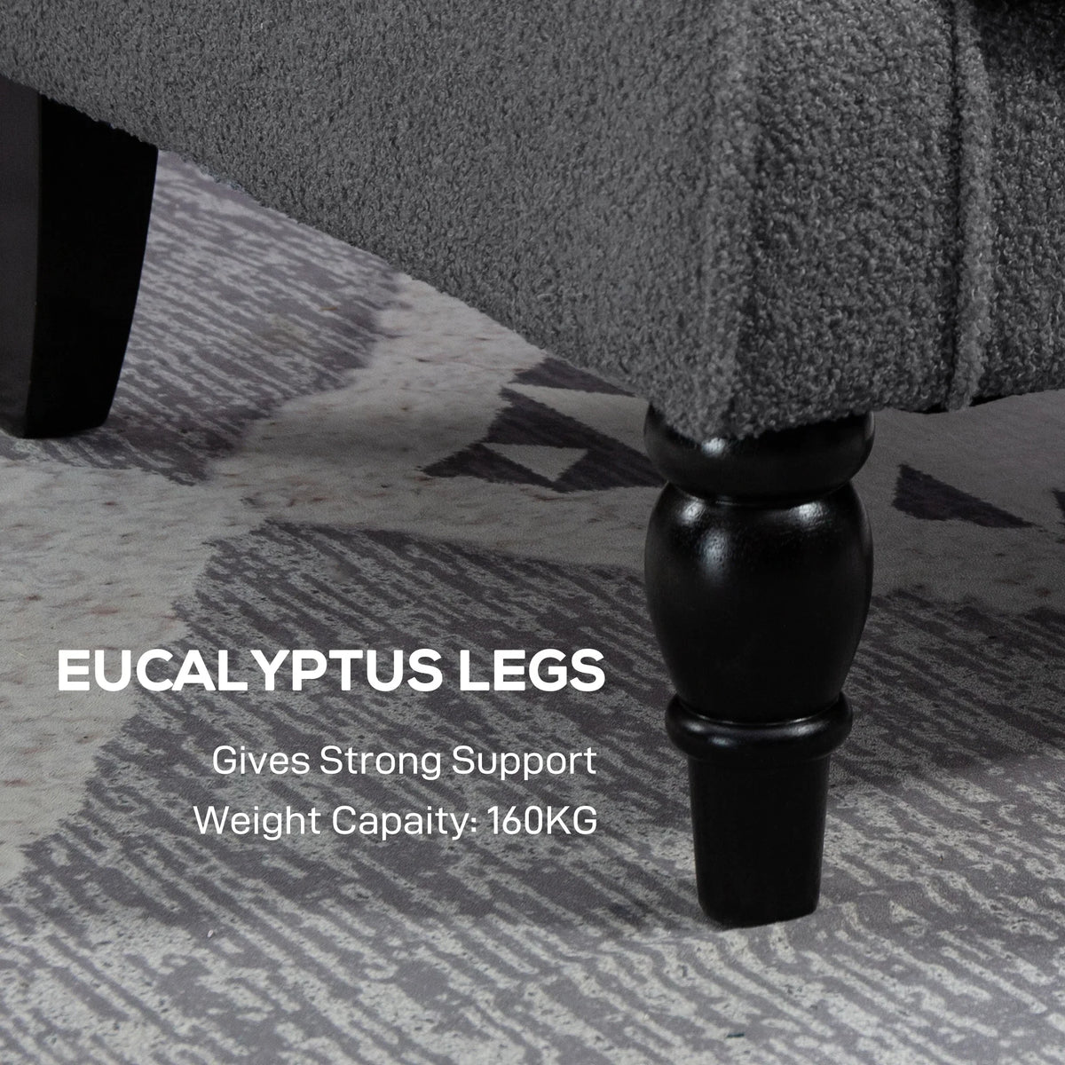 Grey chair with black turned legs and sturdy base on textured floor