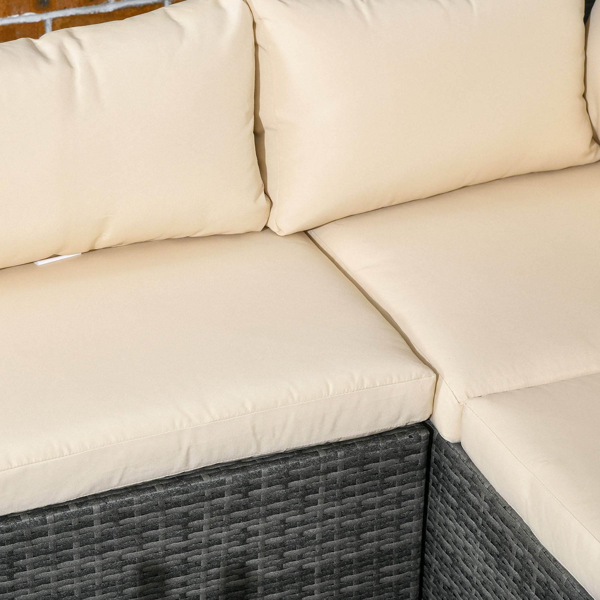 Beige seat cushion with stitched edges on dark gray woven rattan sofa base