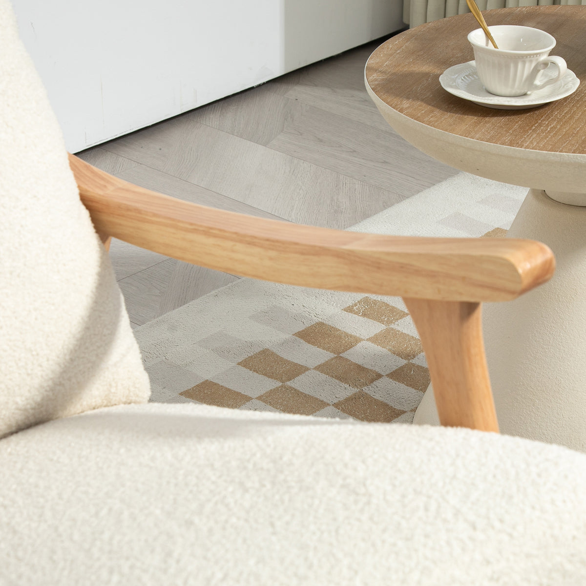 Cream upholstered rocking chair close-up of side armrest and curved wooden base