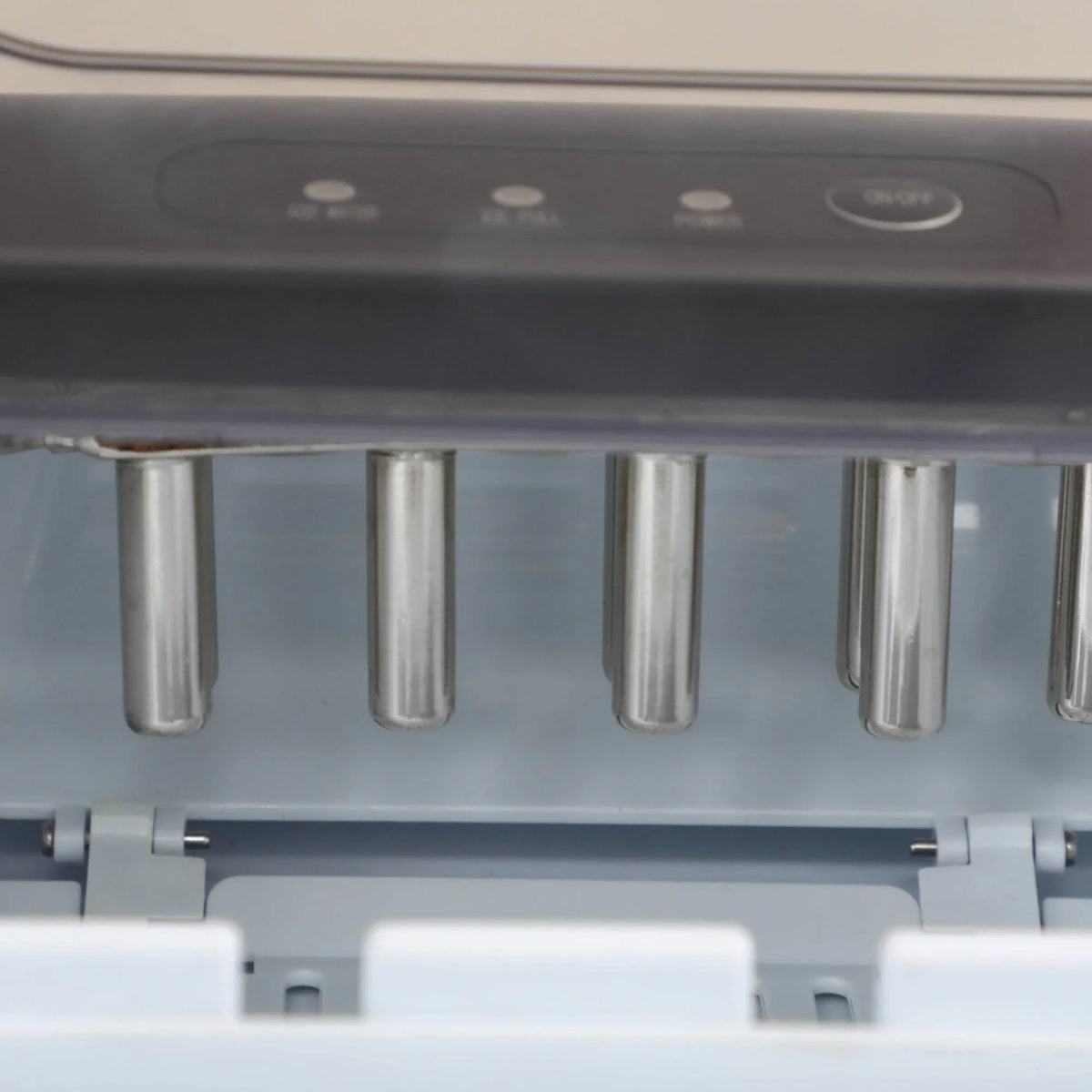 Close-up of the black ice maker’s ice tray with metal bullet ice molds