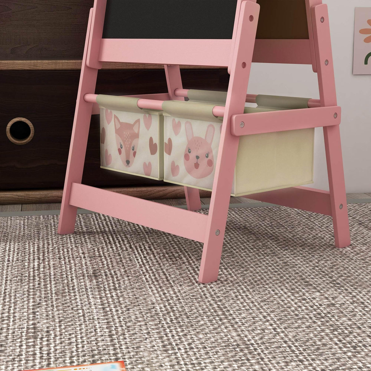 Pink art easel with foldable board and two animal-pattern storage baskets