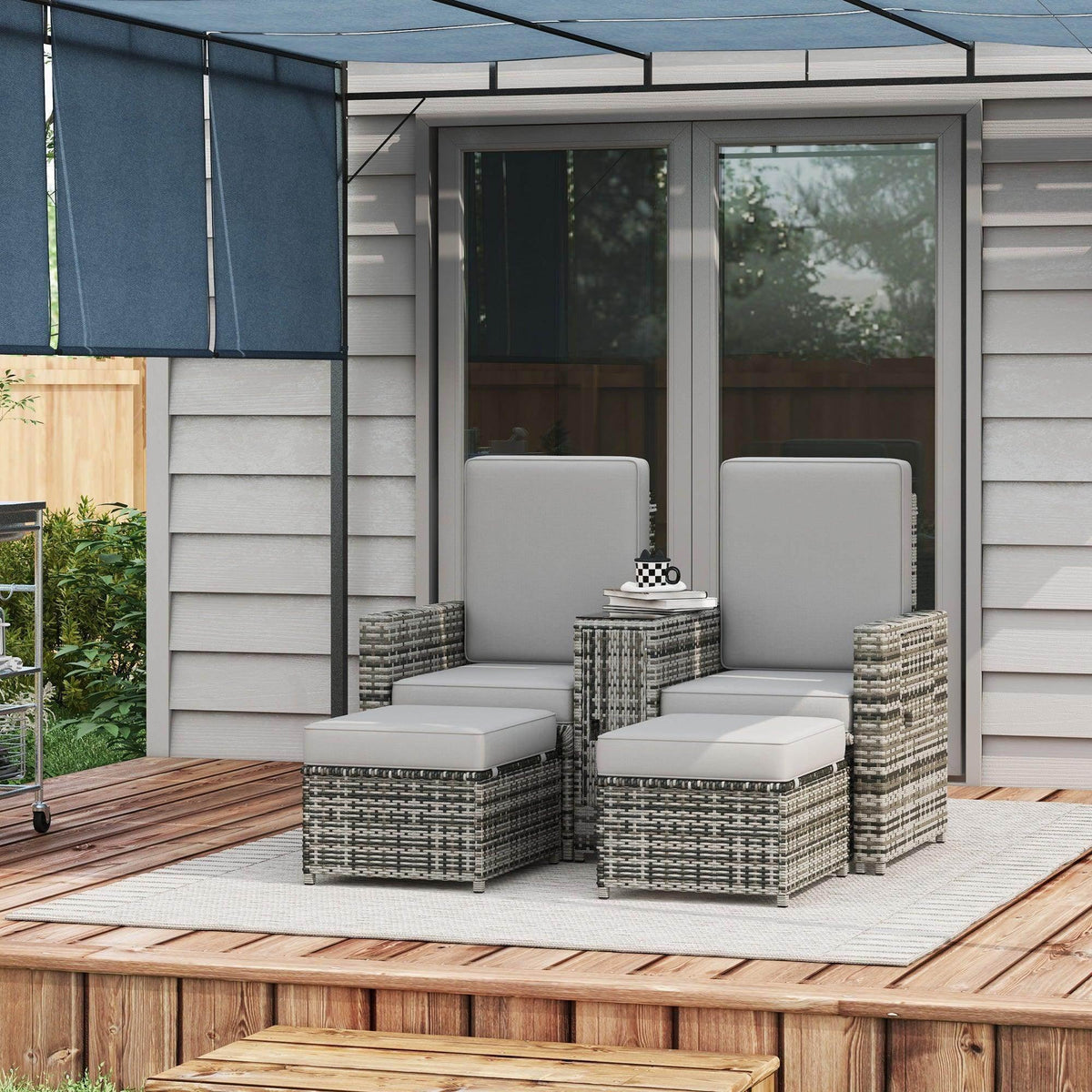 Grey rattan sun lounger set with storage tea table and two matching ottomans