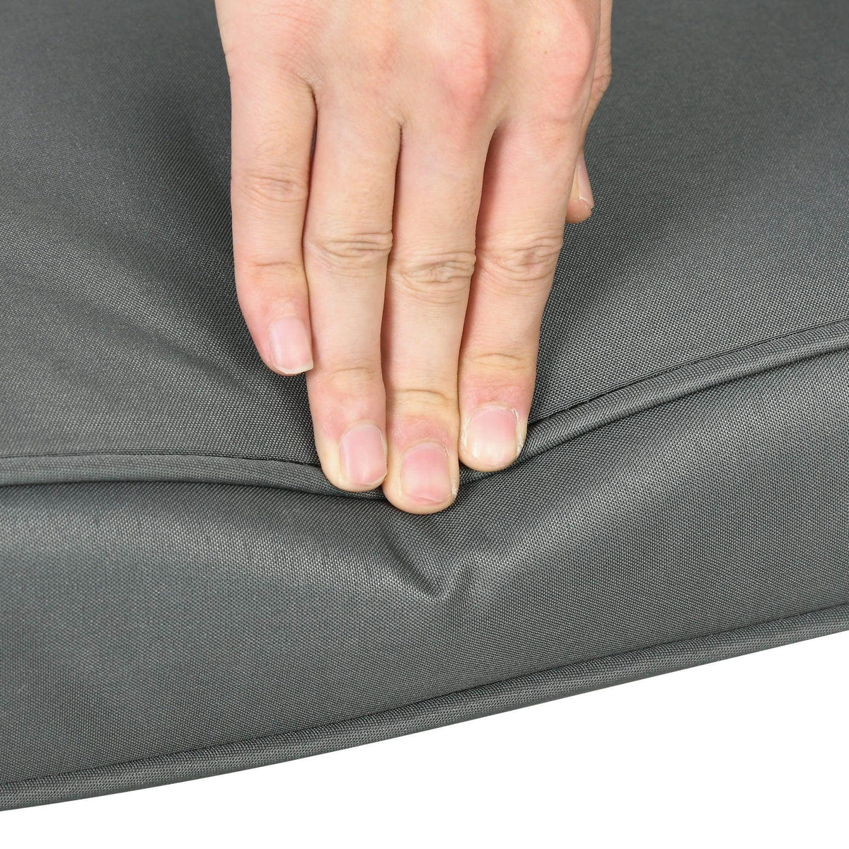 Dark gray seat cushion pad with hand pressing to show soft, cushioned feel