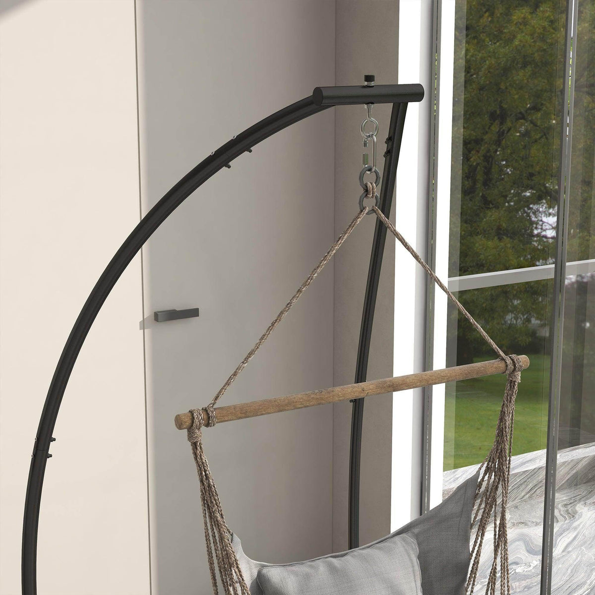 Black arched hammock chair stand with rope swing seat hanging from chain
